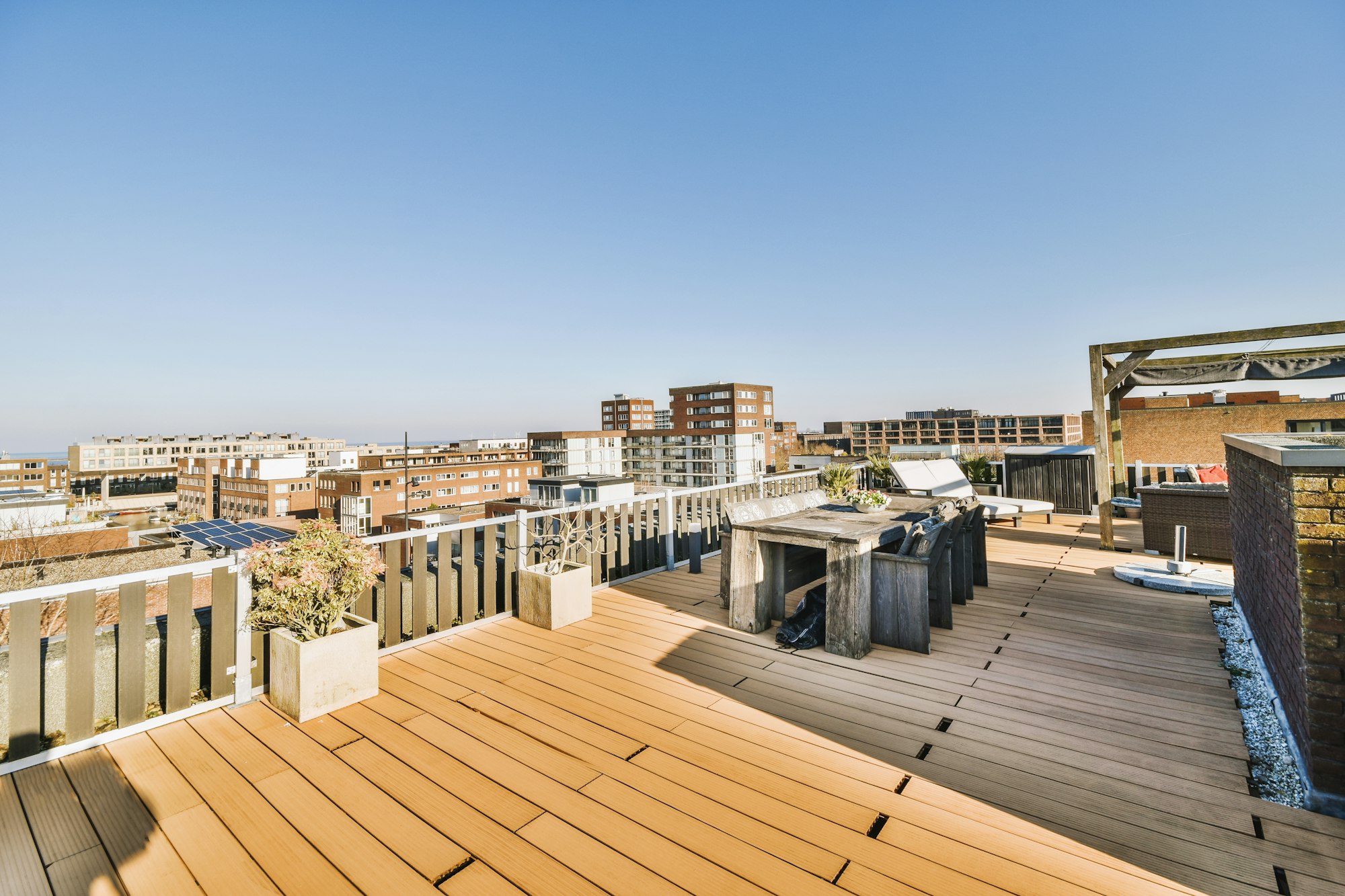 Terrace with table and chairs on the roof of the house